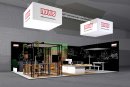 Der Novus Messestand auf der Orgatec 2024 verspricht auf rund 100 Quadratmetern durchdachte Lösungen für den Arbeitsplatz der Zukunft – und eine Auszeit vom Messetrubel am Tischkicker.